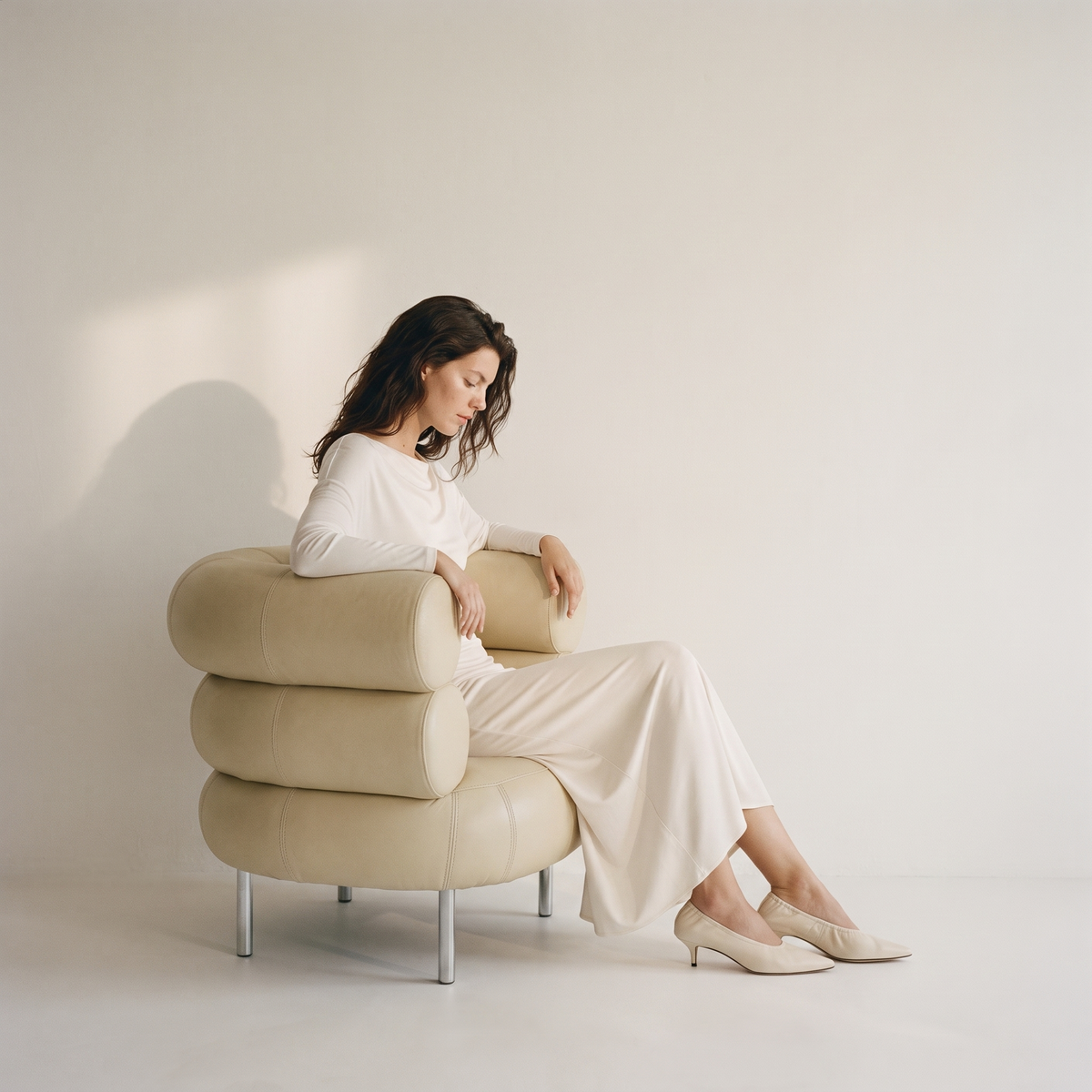 Bone midi dress and cream kitten heels in a cream leather chair