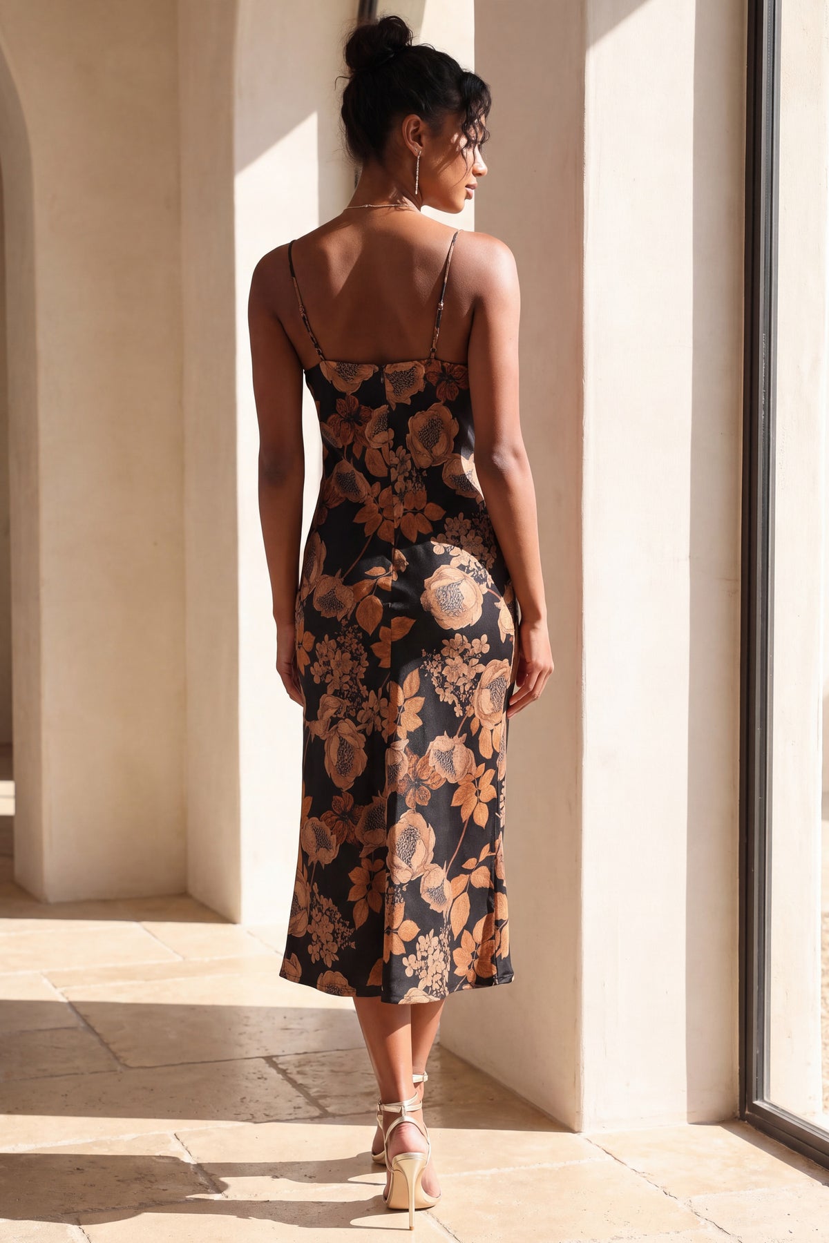 Isolde floral satin slip dress back view beside a tall window