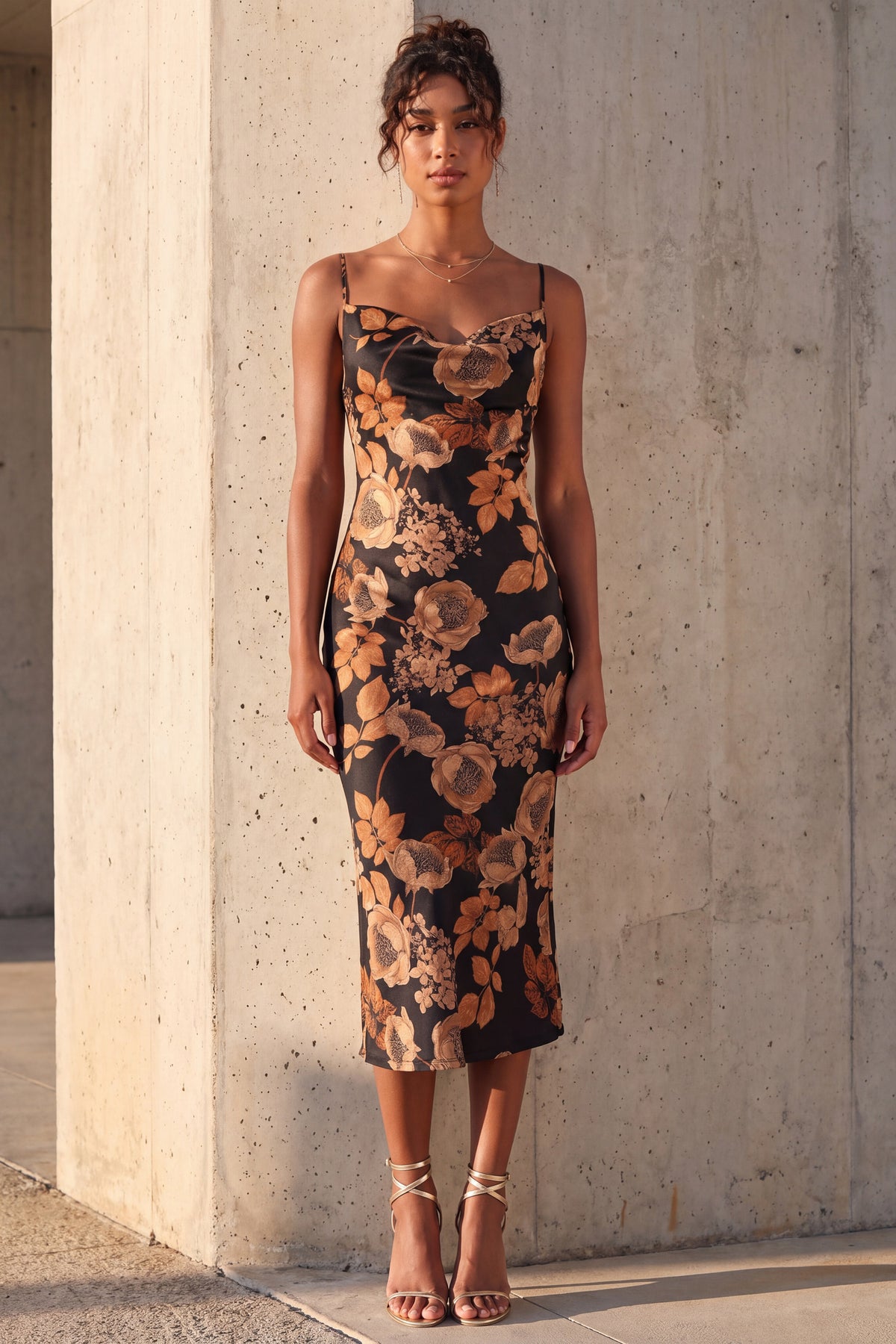 Isolde floral satin slip dress worn full length against a sunlit concrete wall