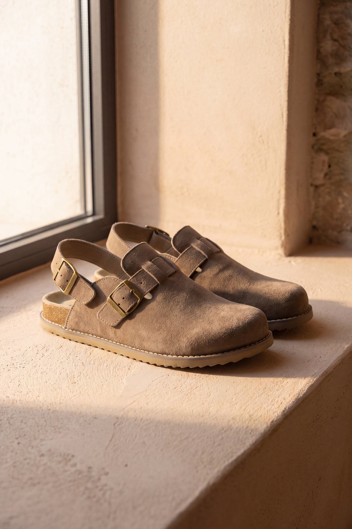 Brookline taupe suede cork footbed clog, pair standing on a warm plaster ledge